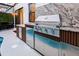 Outdoor kitchen with built-in grill, sink, and stainless steel storage; a functional space for outdoor cooking at 10293 Ebb Tide Ln, Orlando, FL 32821