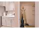 Pantry with sleek white cabinets, white countertops, and essential cleaning supplies inside at 10293 Ebb Tide Ln, Orlando, FL 32821