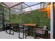 The outdoor patio offers a quiet retreat with elegant tables, chairs, and decorative privacy wall at 10293 Ebb Tide Ln, Orlando, FL 32821