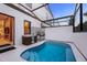 A view of the outdoor pool area with its protective enclosure and outdoor kitchen, perfect for entertaining at 10293 Ebb Tide Ln, Orlando, FL 32821