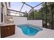 The outdoor pool area is a private retreat with a screened enclosure and stylish outdoor kitchen at 10293 Ebb Tide Ln, Orlando, FL 32821