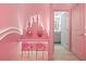 Hallway sitting area with silhouette mirror and pink chairs, with a bathroom view at 10293 Ebb Tide Ln, Orlando, FL 32821