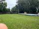 Expansive backyard with mature trees, shed, and above-ground pool at 108 Country Club Cir, Sanford, FL 32771