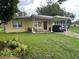 Quaint single-story home with a covered carport and well-maintained front lawn at 108 Country Club Cir, Sanford, FL 32771