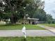 Charming single-story home with a covered carport and mature tree in the front yard at 108 Country Club Cir, Sanford, FL 32771
