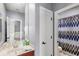 Bathroom with sink and vanity with view to bedroom and shower with patterned curtain at 11425 Claymont Cir, Windermere, FL 34786