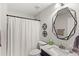 Updated bathroom features a stylish mirror, sleek vanity, and shower-tub combination at 11425 Claymont Cir, Windermere, FL 34786