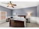 Comfortable bedroom featuring blue walls, a ceiling fan, and large window at 11425 Claymont Cir, Windermere, FL 34786