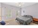 Comfortable bedroom with lilac walls, windows with bright view, and ceiling fan at 11425 Claymont Cir, Windermere, FL 34786