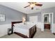 Spacious primary bedroom with blue walls, a ceiling fan, and ensuite bathroom at 11425 Claymont Cir, Windermere, FL 34786