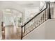 Spacious foyer with hardwood floors, white trim, a staircase with black accents, and an open floor plan at 11425 Claymont Cir, Windermere, FL 34786