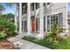 Inviting front porch with stately pillars, black shutters, a cozy bench, and well-maintained landscaping at 11425 Claymont Cir, Windermere, FL 34786