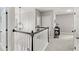 Upstairs hallway with white railings, neutral walls, and modern light fixture at 11425 Claymont Cir, Windermere, FL 34786