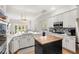 Bright kitchen features white cabinets, stainless steel appliances, a center island, and an open floor plan at 11425 Claymont Cir, Windermere, FL 34786