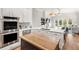 Beautiful kitchen with white cabinets, stainless steel appliances, a center island, and an open view at 11425 Claymont Cir, Windermere, FL 34786