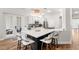 Modern kitchen with a large island, quartz countertops, white cabinets, and stainless steel appliances at 11425 Claymont Cir, Windermere, FL 34786