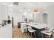 Bright, open kitchen with white cabinetry, hardwood floors, and a large center island with bar seating at 11425 Claymont Cir, Windermere, FL 34786