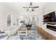 Bright and airy living room with open floor plan, hardwood floors, and fireplace with white shiplap at 11425 Claymont Cir, Windermere, FL 34786