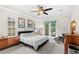 Bright main bedroom with a comfortable bed, modern furniture, and private outdoor access at 11425 Claymont Cir, Windermere, FL 34786