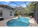 Screened-in pool area featuring a lovely pool, brick pavers, a sunbathing chair, and a well-maintained fence at 11425 Claymont Cir, Windermere, FL 34786