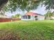 Expansive backyard featuring a screened in porch and wood fence, perfect for outdoor enjoyment and privacy at 11500 Benbow Ct, Orlando, FL 32837