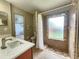 Bathroom featuring shower with unique tilework and marble countertop at 11500 Benbow Ct, Orlando, FL 32837