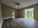 Bright bedroom with wood-look floors, ceiling fan, and sliding glass doors to the backyard at 11500 Benbow Ct, Orlando, FL 32837