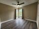 Cozy bedroom with wood-look floors and two windows bringing in lots of natural light at 11500 Benbow Ct, Orlando, FL 32837