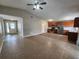 Spacious open-concept living room and kitchen area with modern tile flooring and stainless appliances at 11500 Benbow Ct, Orlando, FL 32837