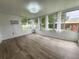 Enclosed sunroom featuring wood-look flooring and lots of windows offering natural light at 11500 Benbow Ct, Orlando, FL 32837