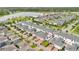 An aerial shot capturing the back of the townhomes and the garages. Landscaping includes lush green grass at 12015 Prologue Ave, Orlando, FL 32832