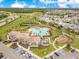 Aerial view of the community pool, playground, tennis courts and surrounding neighborhood at 12015 Prologue Ave, Orlando, FL 32832