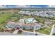 Aerial view of the resort-style pool and clubhouse with tennis courts and lush landscaping at 12015 Prologue Ave, Orlando, FL 32832