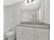 Bright bathroom featuring white cabinets, gray countertop, and bathtub with tile surround at 12015 Prologue Ave, Orlando, FL 32832
