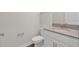 Bathroom featuring white cabinets, granite countertop, and modern faucet at 12015 Prologue Ave, Orlando, FL 32832