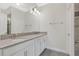 Bright bathroom featuring a double vanity, gray countertop, and modern fixtures at 12015 Prologue Ave, Orlando, FL 32832