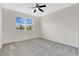 Bright bedroom featuring a large window, plush carpeting, and ample natural light at 12015 Prologue Ave, Orlando, FL 32832