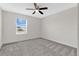 Bright bedroom featuring neutral walls, ceiling fan, and carpet flooring at 12015 Prologue Ave, Orlando, FL 32832