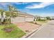 The brick paved driveway leads to a two-car garage with manicured landscaping that adds curb appeal at 12015 Prologue Ave, Orlando, FL 32832