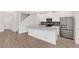 Modern kitchen features stainless steel appliances, a large island, and stylish cabinetry at 12015 Prologue Ave, Orlando, FL 32832