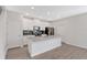 Modern kitchen features stainless steel appliances, a large island, and stylish cabinetry at 12015 Prologue Ave, Orlando, FL 32832