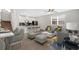 Bright living room with sleek flooring, modern decor, and a seamless open floor plan at 12015 Prologue Ave, Orlando, FL 32832