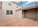 A charming patio featuring red brick pavers and access to the home's side entrance and covered area at 12015 Prologue Ave, Orlando, FL 32832