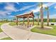 Picturesque outdoor pavilion featuring picnic tables, set amongst palm trees and manicured lawns at 12015 Prologue Ave, Orlando, FL 32832