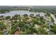 Expansive aerial view of a neighborhood adjacent to a lake, showcasing lush greenery and residential charm at 1227 Golden Ln, Orlando, FL 32804
