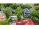 Aerial view of the property, highlighted by a backyard pool, lush landscaping, and privacy at 1227 Golden Ln, Orlando, FL 32804