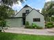 Rear elevation displaying stucco and window design, garden, and private fenced yard at 1227 Golden Ln, Orlando, FL 32804