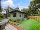 Charming home featuring a well-manicured backyard, vibrant landscaping, and a cozy patio space at 1227 Golden Ln, Orlando, FL 32804