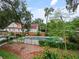 Backyard featuring a pool with lounge chairs and lush landscaping, perfect for relaxing and entertaining at 1227 Golden Ln, Orlando, FL 32804