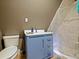 Cozy bathroom with a blue vanity, toilet, and shower with a clear curtain at 1227 Golden Ln, Orlando, FL 32804